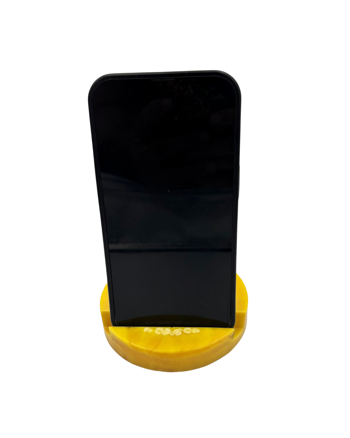 A black smartphone displayed upright on a small yellow circular stand against a plain white background.
