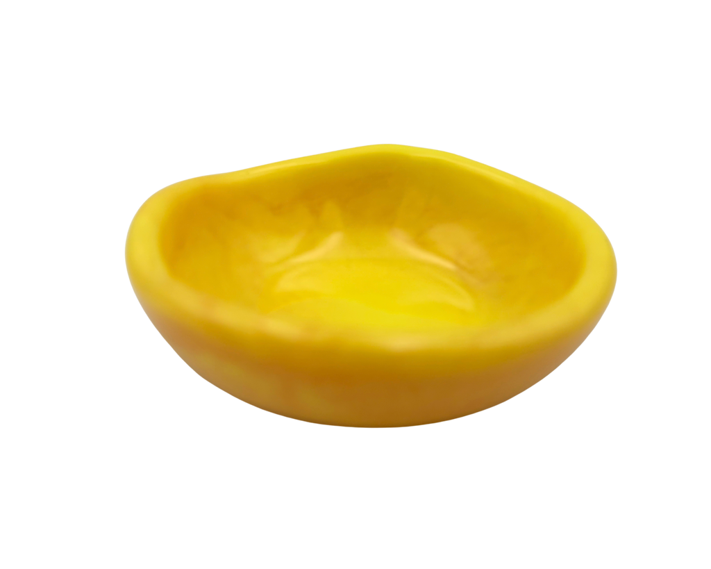 A small, shallow, asymmetrical yellow bowl with a smooth, glossy finish, isolated on a white background.