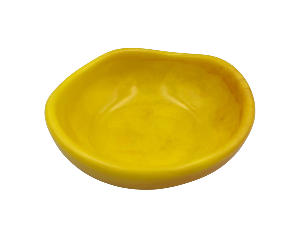 A small, shallow, asymmetrical yellow bowl with a smooth, glossy finish, isolated on a white background.